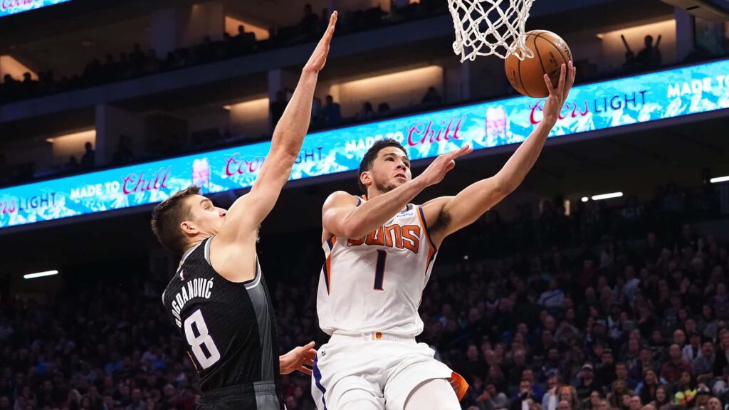 Bogdan Bogdanović blocking a layup by Phoenix Suns player intense basketball action wallpaper