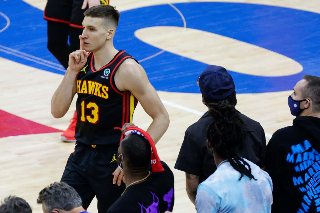 Bogdan Bogdanović in Atlanta Hawks uniform courtside making gesture fans and teammates watching Wallpaper