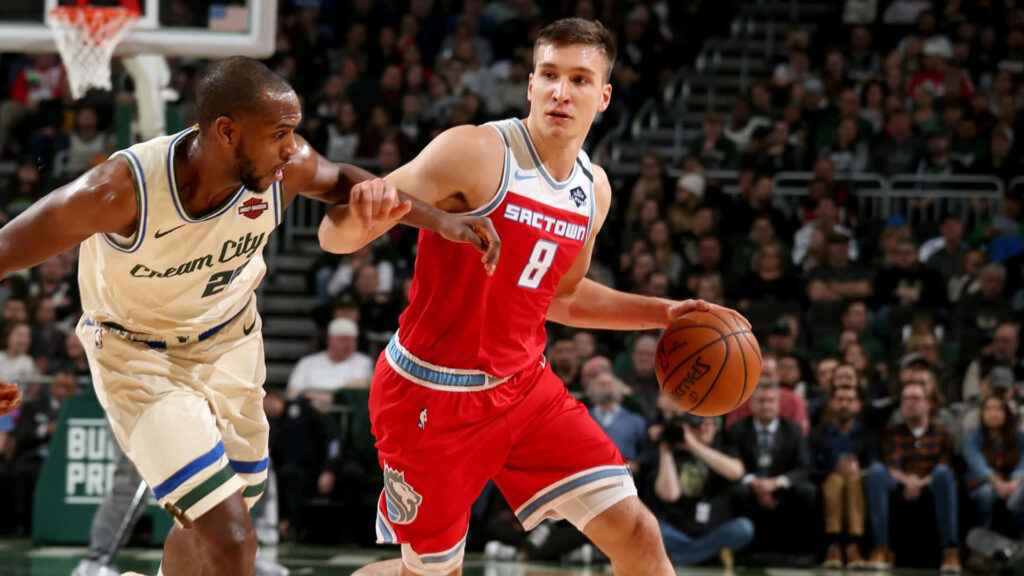 Bogdan Bogdanović dribbles past Khris Middleton in intense NBA basketball game action wallpaper