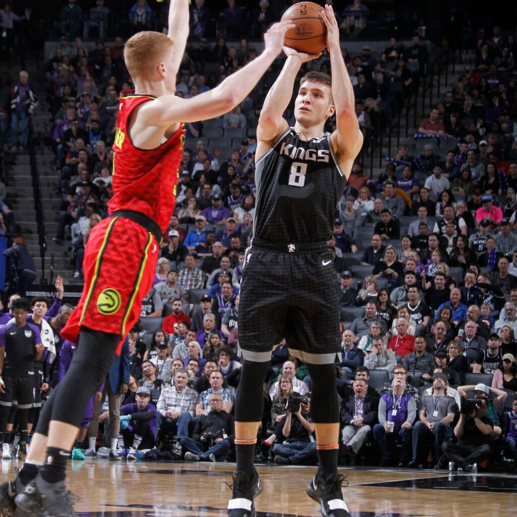 Bogdan Bogdanović midair jump shot showcasing focus and skill on court dynamic basketball wallpaper