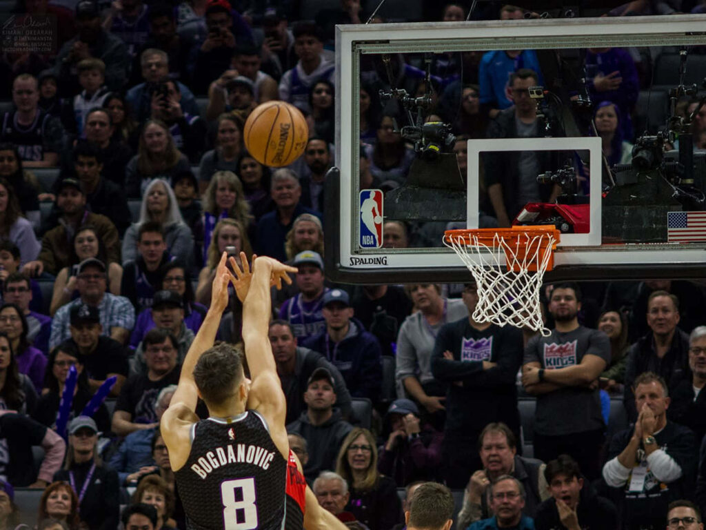 Bogdan Bogdanović shooting basketball in NBA game with energized crowd in arena wallpaper background