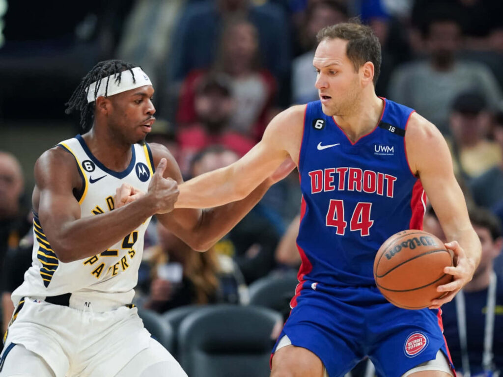 Bojan Bogdanovic drives past Buddy Hield in intense Detroit Pistons vs Indiana Pacers NBA game Wallpaper
