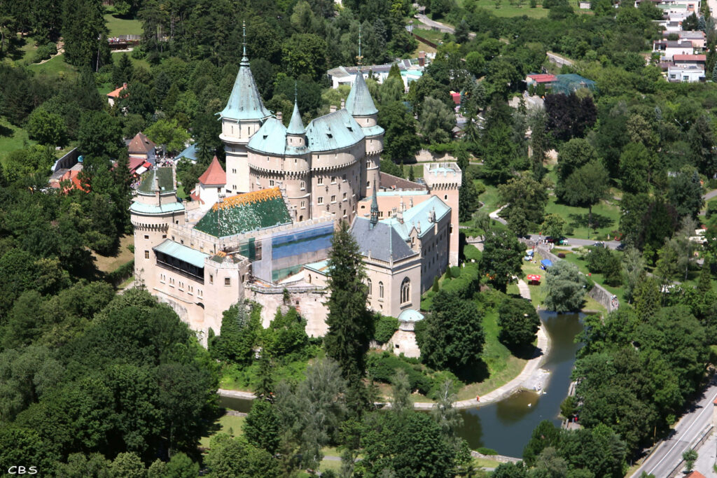 Bojnice Castle in Slovakia surrounded by lush gardens and moat stunning medieval landscape wallpaper