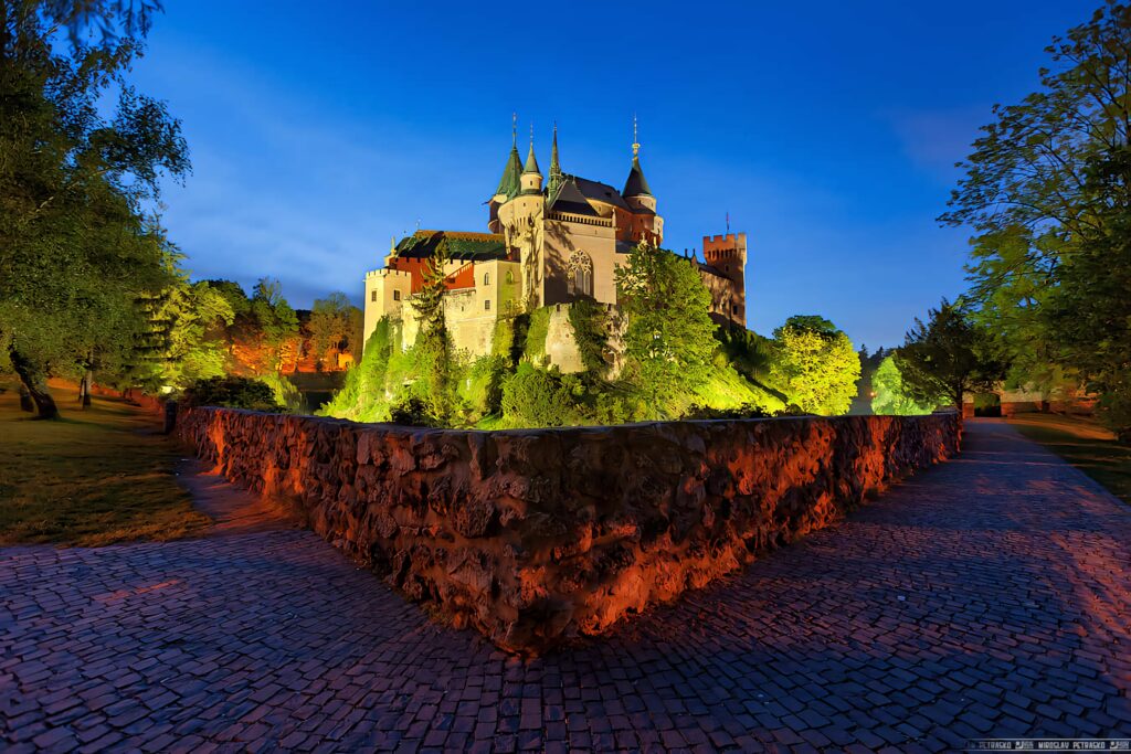 Bojnice Castle Slovakia illuminated at twilight with fairytale turrets and lush gardens wallpaper
