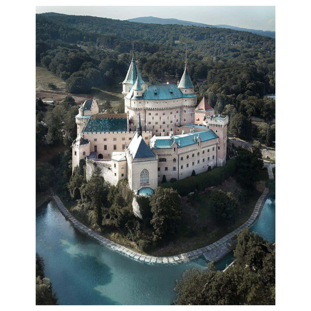 Bojnice Castle Slovakia medieval architecture lush greenery tranquil water scenic wallpaper view