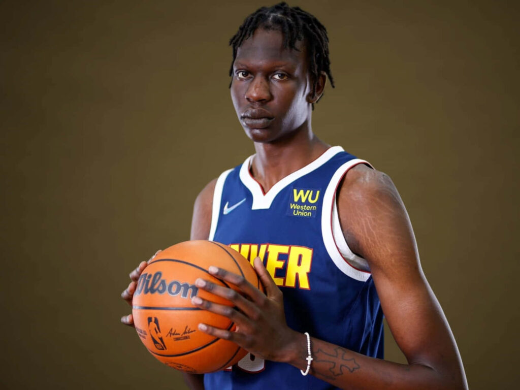 Bol Bol in Denver Nuggets jersey holding basketball dynamic wallpaper for basketball fans