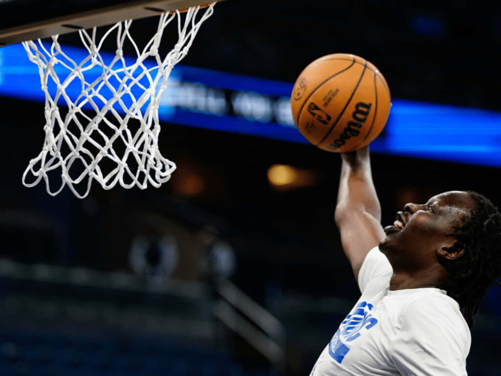 High-resolution action shot of Bol Bol mid-air slam dunk vibrant basketball wallpaper background