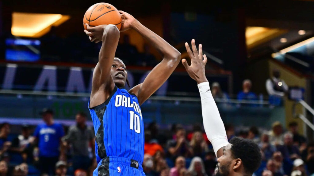 Bol Bol Orlando Magic shooting over defender in blue jersey number 10 vibrant arena wallpaper