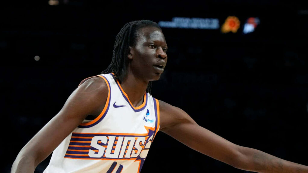 Bol Bol Phoenix Suns basketball wallpaper action shot intense focus stadium lights background