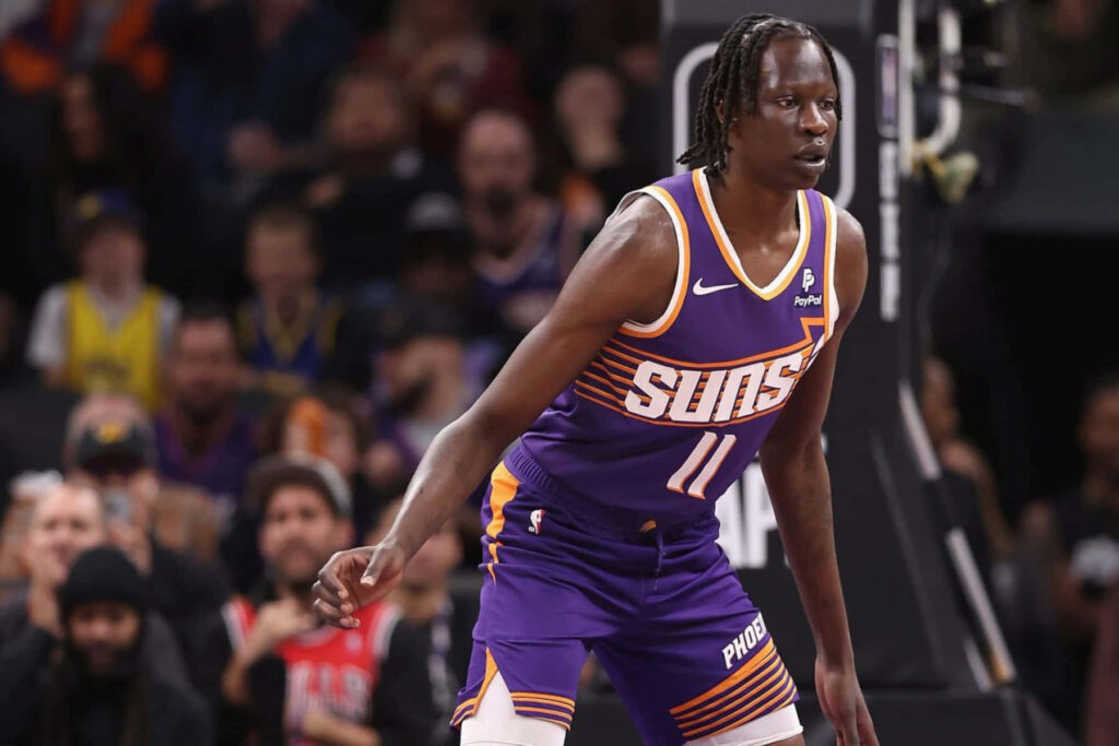 Bol Bol Phoenix Suns dynamic game action in purple jersey intense basketball moment wallpaper