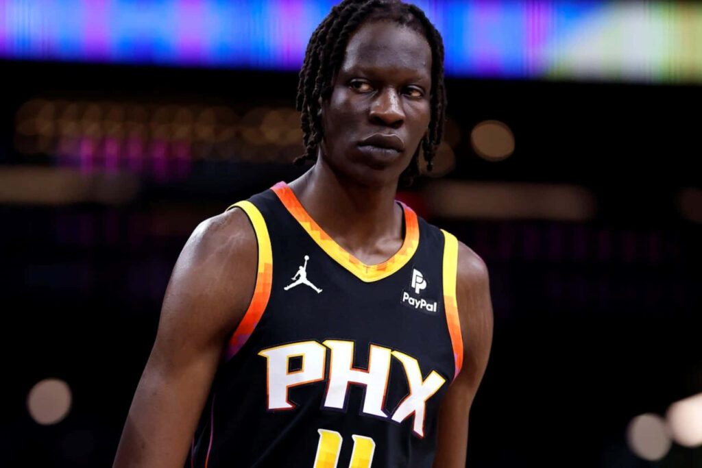 Bol Bol in Phoenix Suns jersey dynamic wallpaper black orange court modern sports photo background