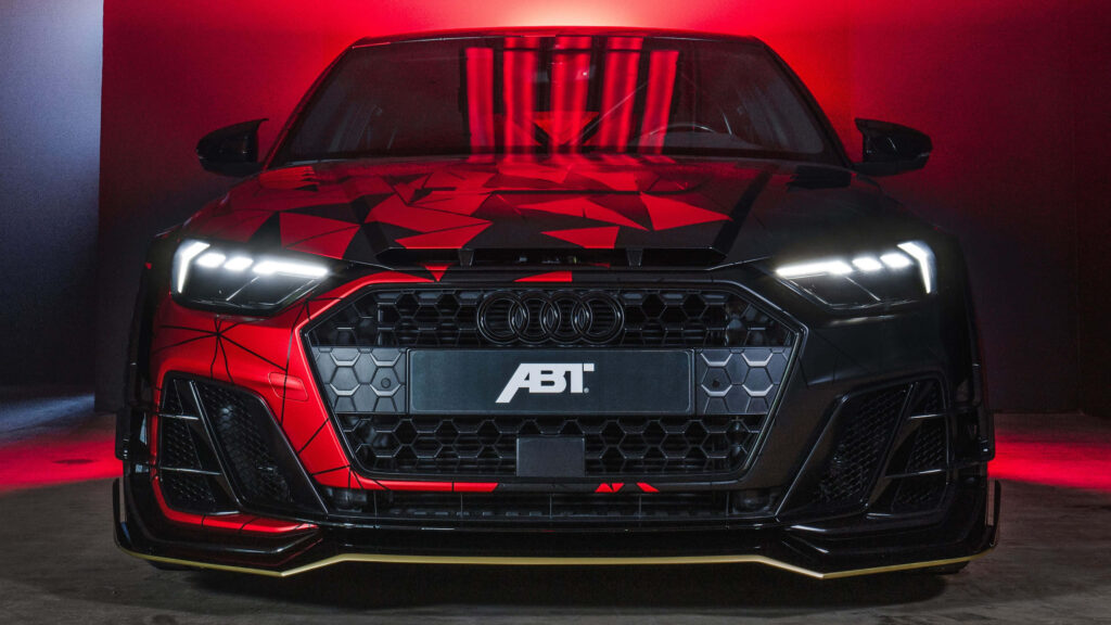 Audi sports car with bold geometric patterns and glowing lights on red black background wallpaper