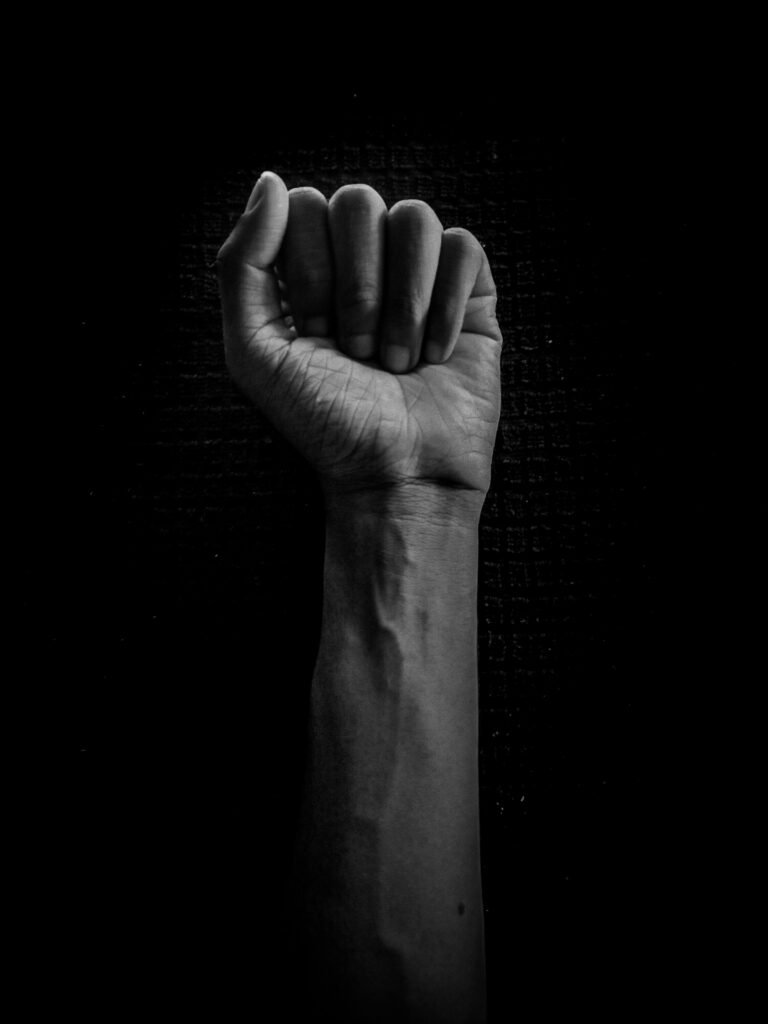 Bold Black and White Wallpaper: Raised Fist Symbolizing Strength