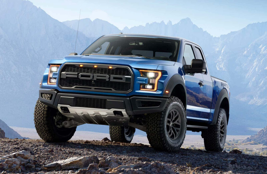 Bold blue Ford Ranger conquers rugged terrain with mountains off-road adventure wallpaper background