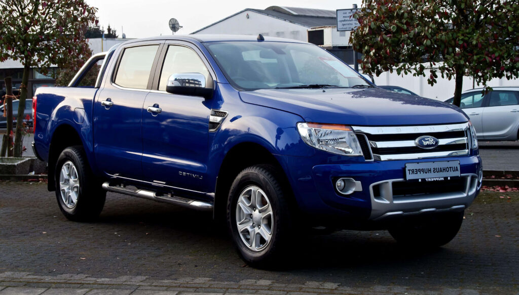 Bold blue Ford Ranger Raptor on pavement showcasing rugged design and strong truck presence Wallpaper