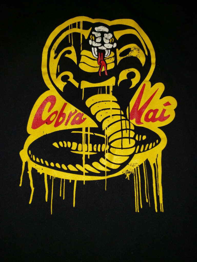 Edgy Cobra Kai Phone Wallpaper: Bold Dripping Yellow Cobra Design
