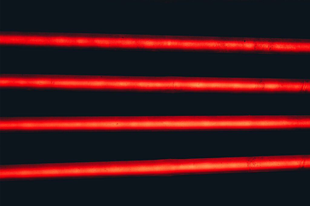 A Dazzling Fusion: Neon Red and Black Stripes Embrace in a Captivating Visual Wallpaper