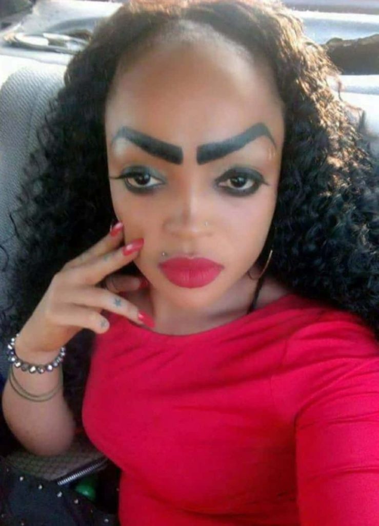 Person with bold arched eyebrows dark curly hair dramatic red lipstick vibrant red top selfie Wallpaper