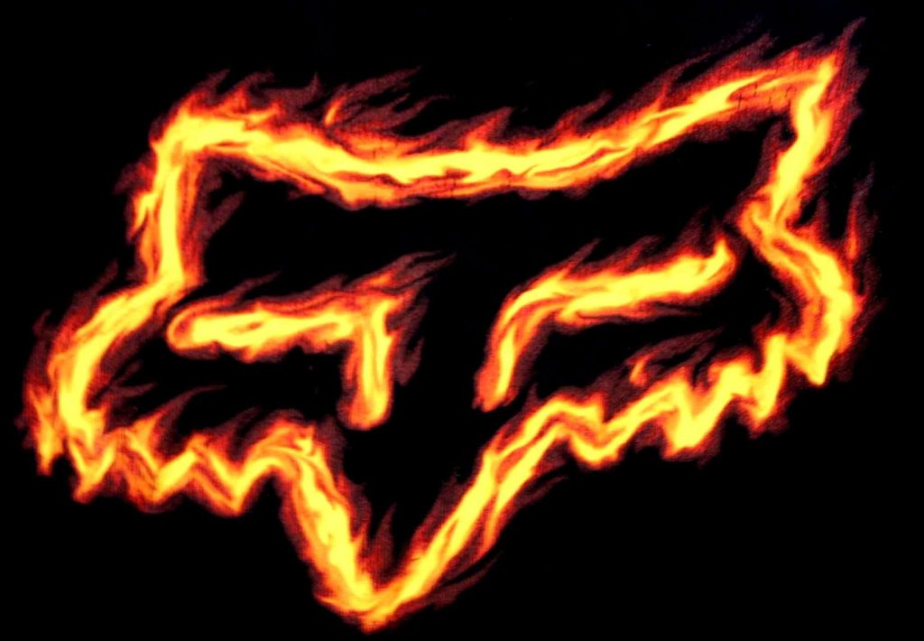 Fox Racing logo in vibrant orange yellow flames on black intense motocross wallpaper background