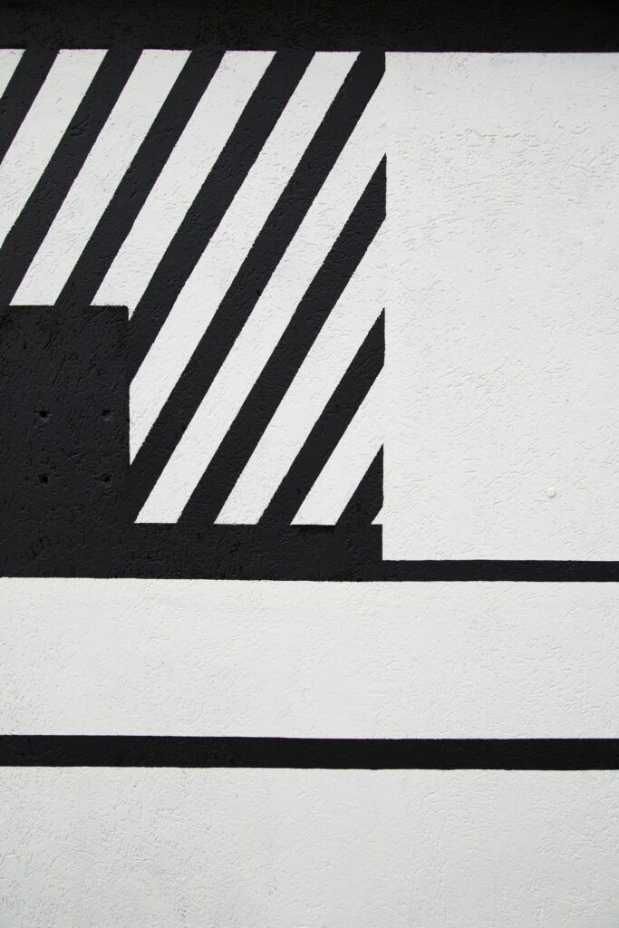 Bold Geometric Black & White Striped Wallpaper on Textured Background