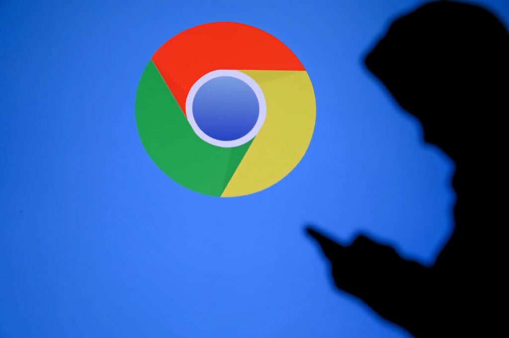 Google Chrome logo on blue background with person using smartphone symbolizing digital connectivity Wallpaper