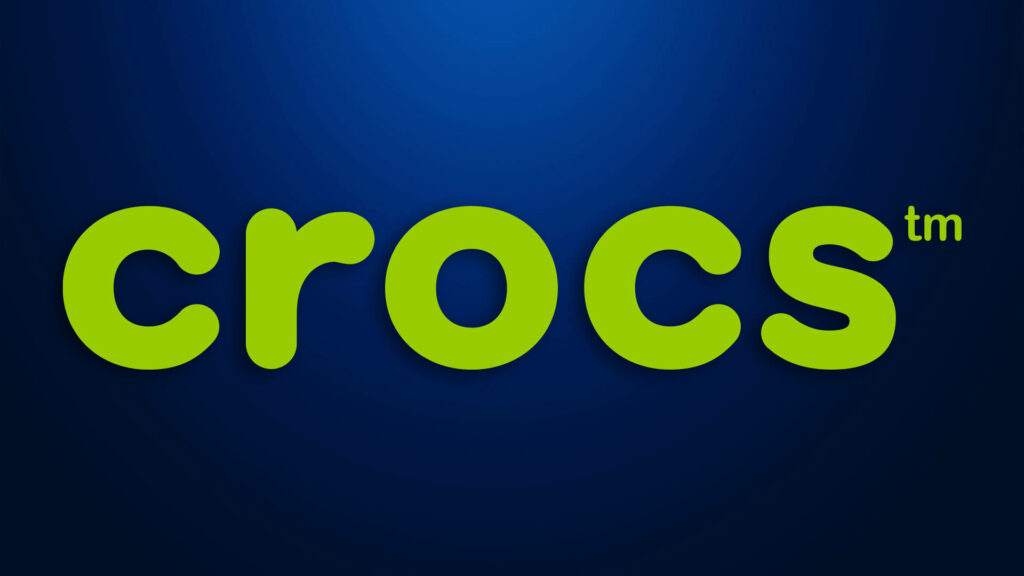 Bold green Crocs logo on deep blue gradient background with modern playful style wallpaper