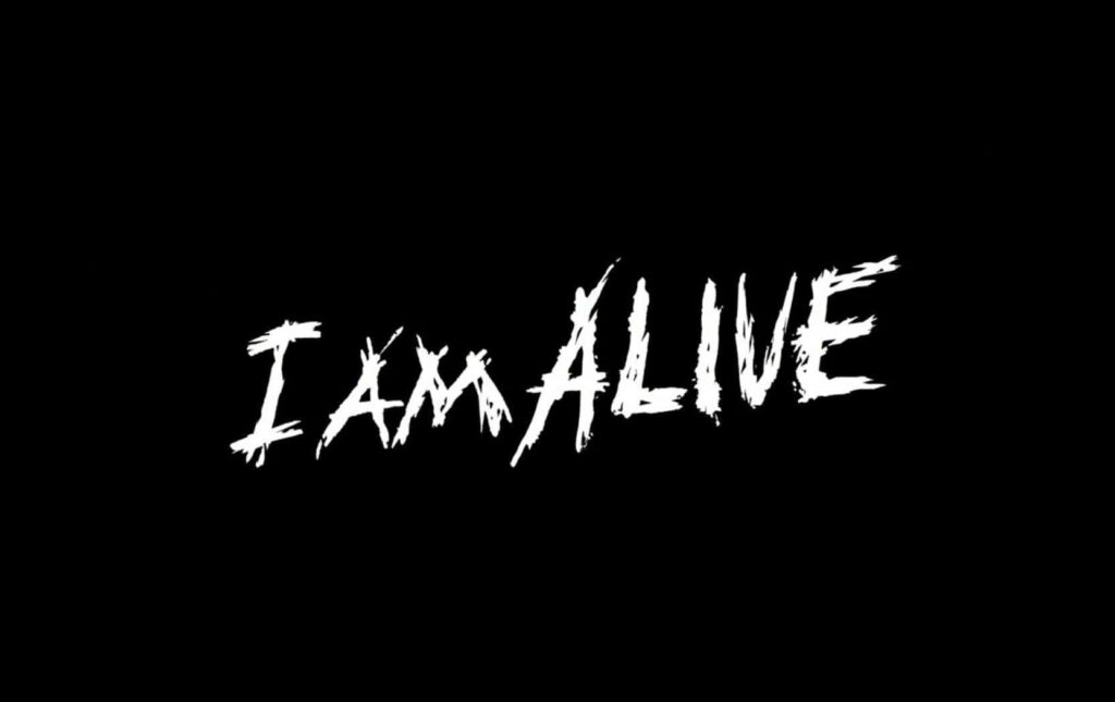 “Bold I AM ALIVE Wallpaper: Distressed White Text on Black Background”