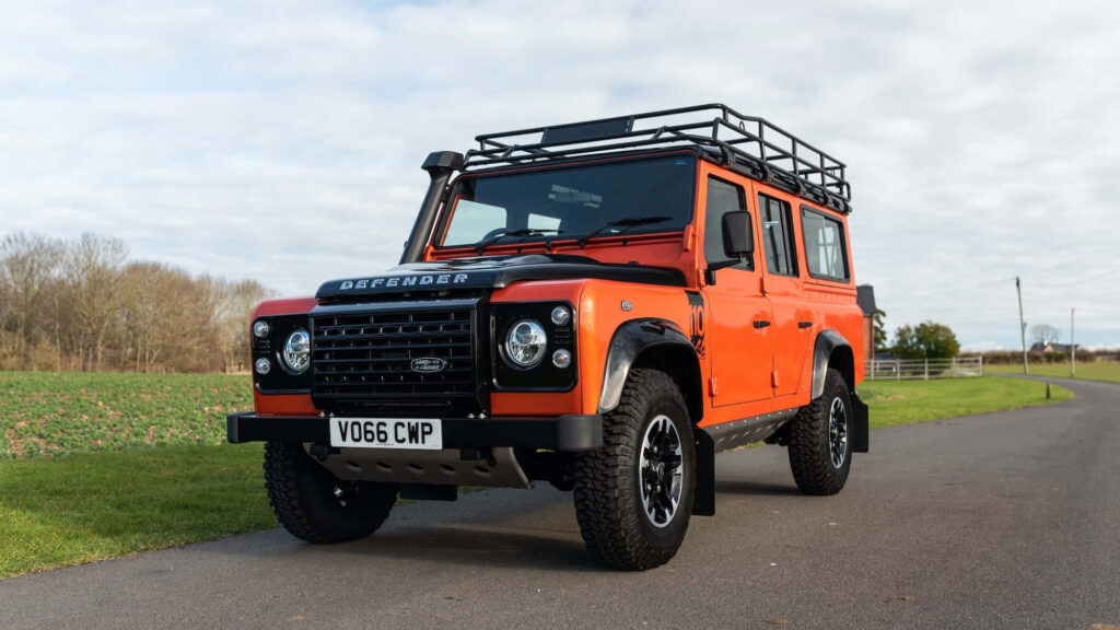 Bold Land Rover Defender Wallpaper: Rugged Adventure in Orange