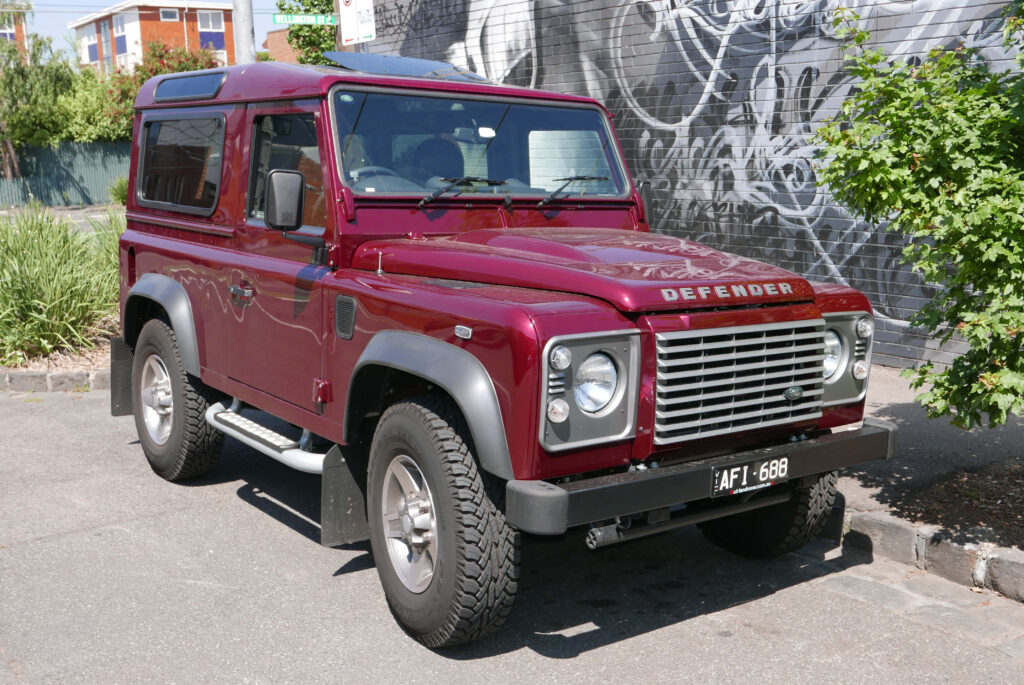 Classic Land Rover Defender: Rugged Urban Wallpaper Background