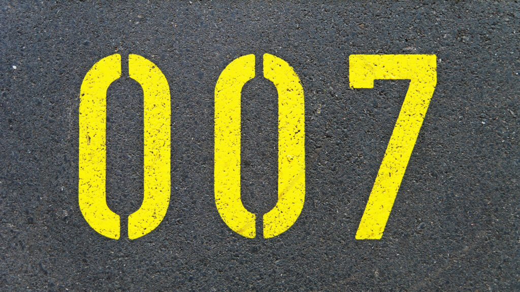 Bold 007 Minimalist Wallpaper: Yellow Icon on Black Texture