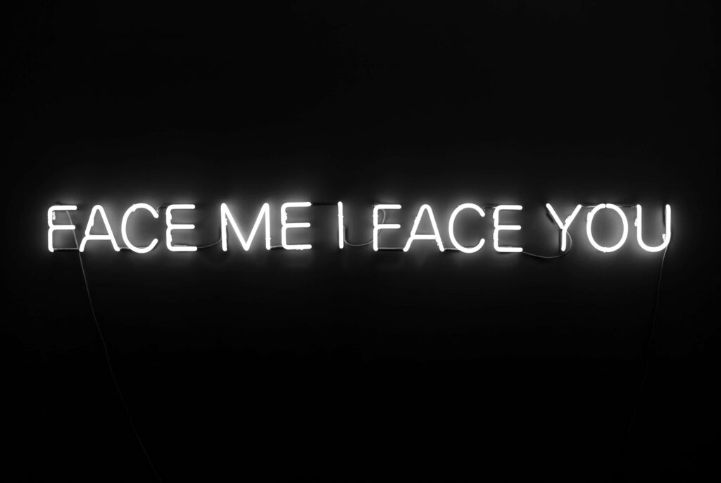 Illuminated Neon 'FACE ME I FACE YOU' Wallpaper on Dark Background