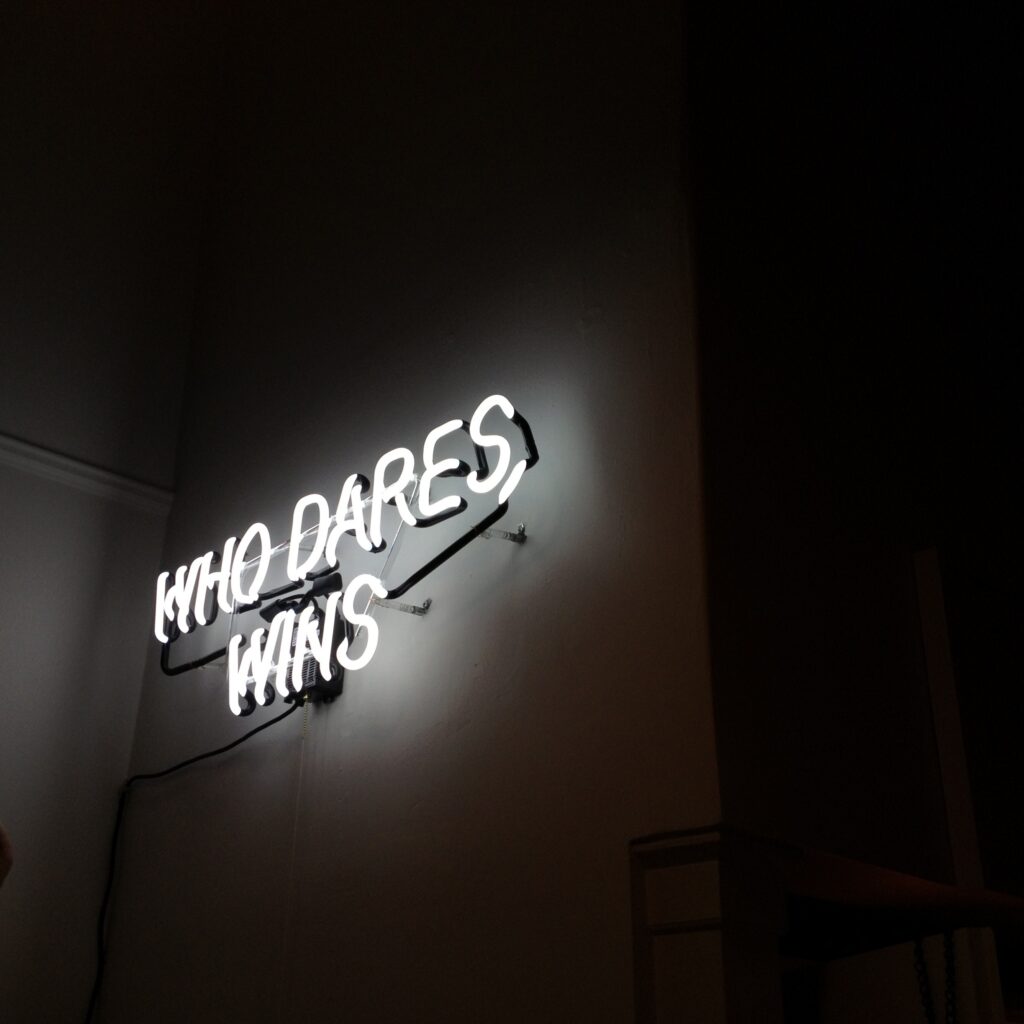 Neon 'Who Dares Wins' Wallpaper: Bold Dark Wall Inspiration