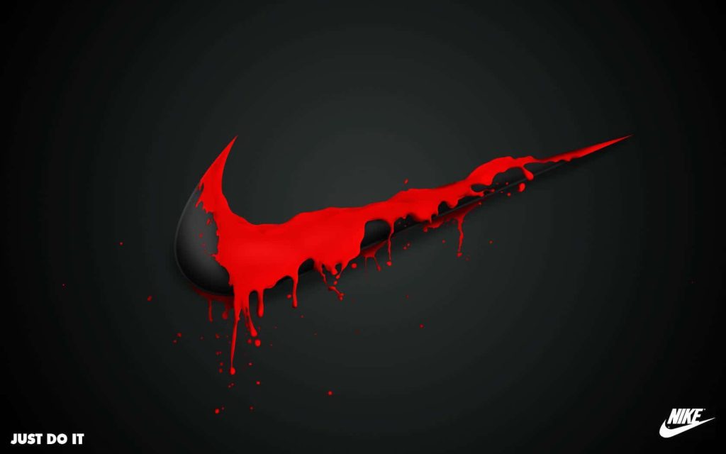 Bold Nike Swoosh with red paint drip on black background and Just Do It slogan wallpaper