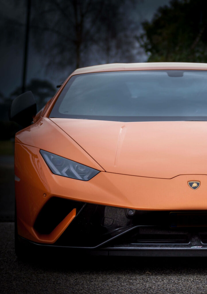 Front view of orange Lamborghini with sharp design perfect for iPhone wallpaper background