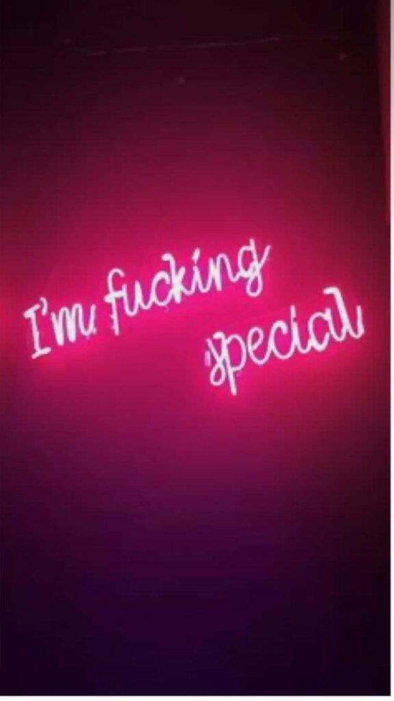 Bold Pink Neon Motivational Wallpaper on Dark Background