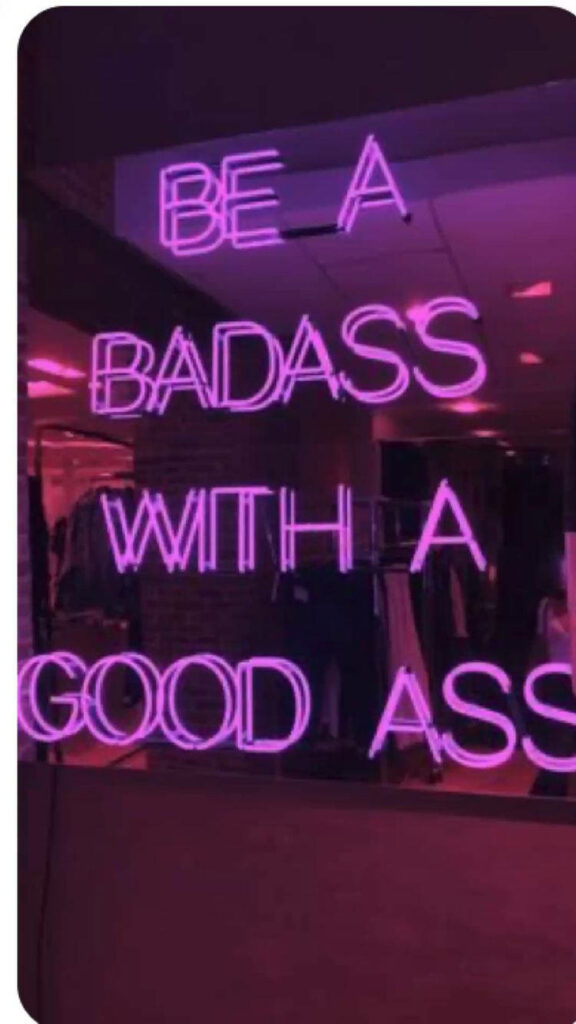 Bold Pink Neon Wallpaper on Reflective Surface - Edgy & Energetic