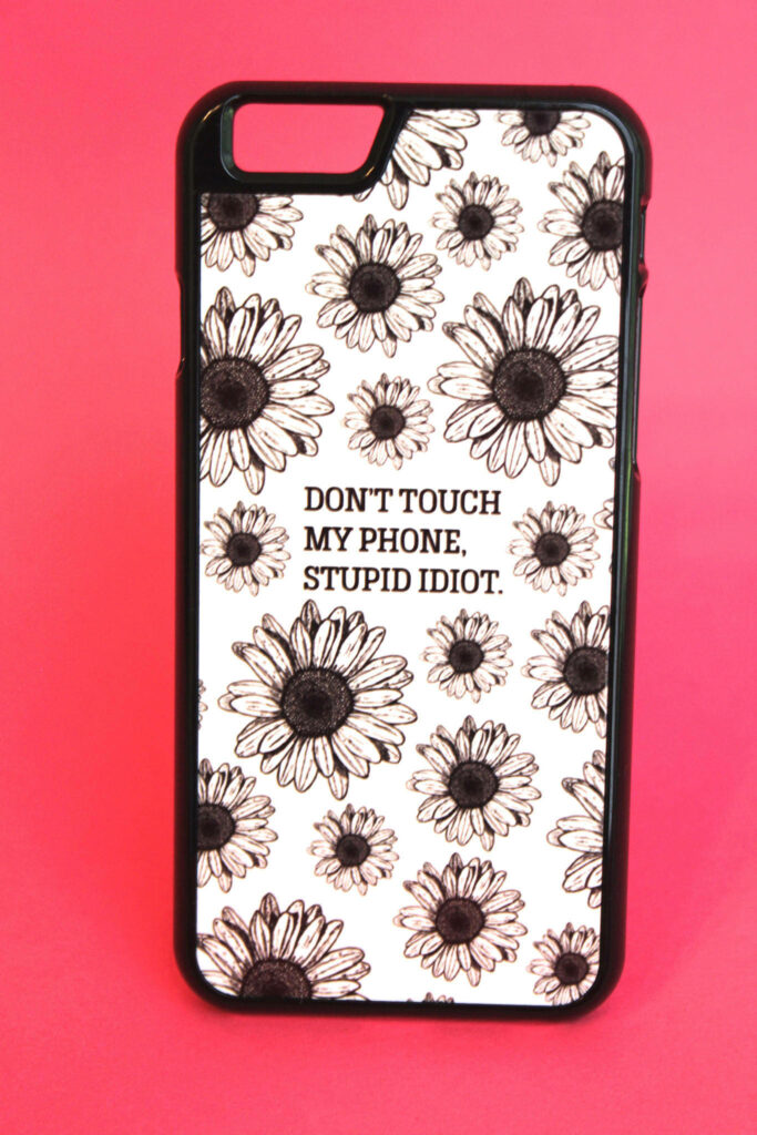 Black and white sunflower pattern with bold Dont Touch My Phone Stupid Idiot text on pink background Wallpaper