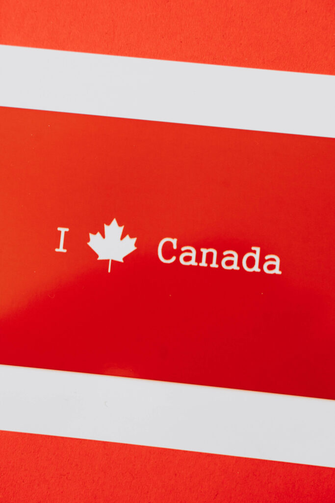 Bold red wallpaper with a white maple leaf symbolizing Canadian heritage and national pride