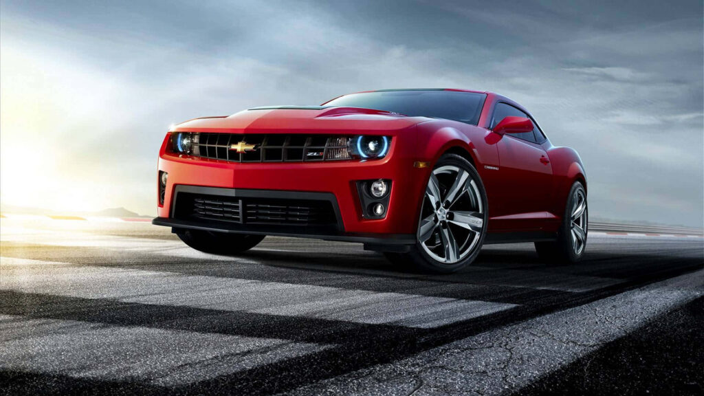 Bold red Chevrolet car on racetrack HD wallpaper showcasing modern sporty design and power