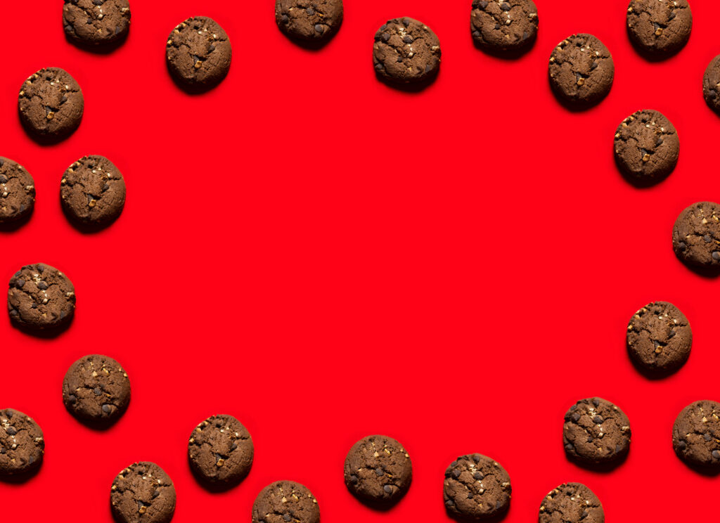 Bold red wallpaper with evenly spaced chocolate chip cookie border for a playful food design