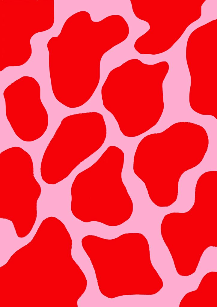 Bold red cow print wallpaper on soft pink background modern pop art colorful statement design