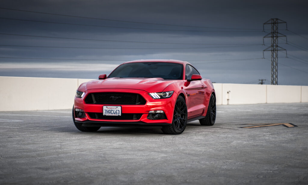 Bold Red Ford Mustang Wallpaper: Sleek Design on Minimalist Background