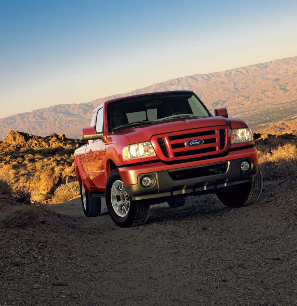 Bold red Ford Ranger truck in rugged desert landscape showcasing strength and adventure wallpaper