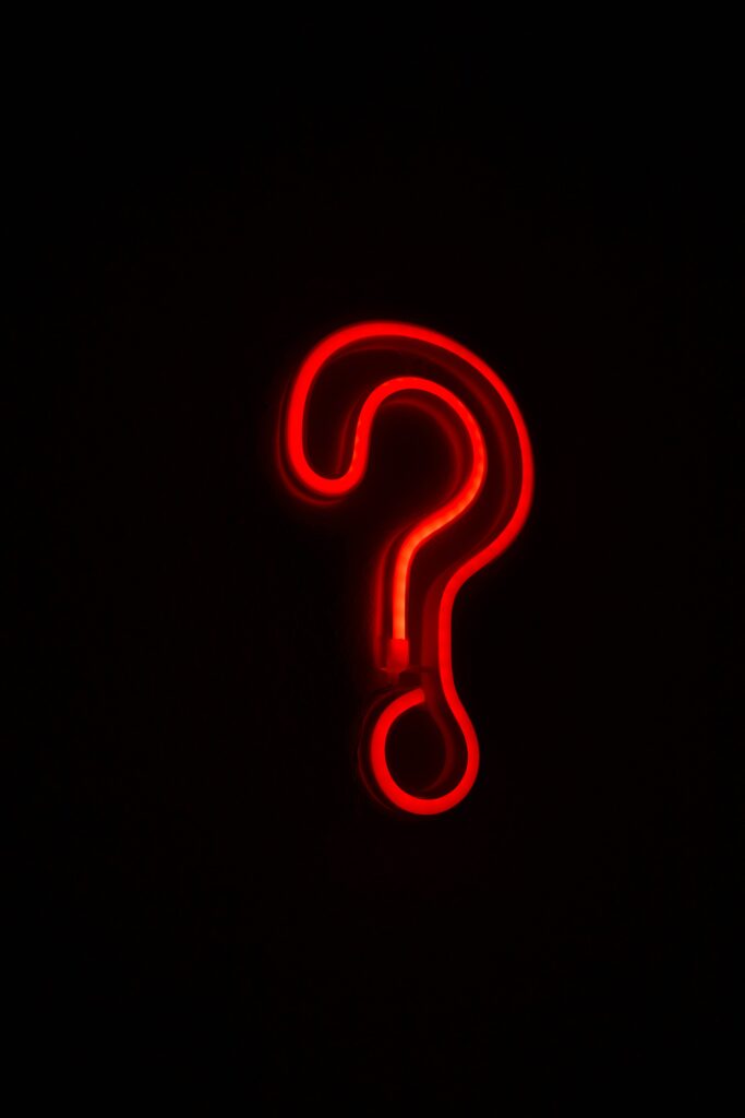 Bold Red Neon Question Mark Wallpaper on Dark Background