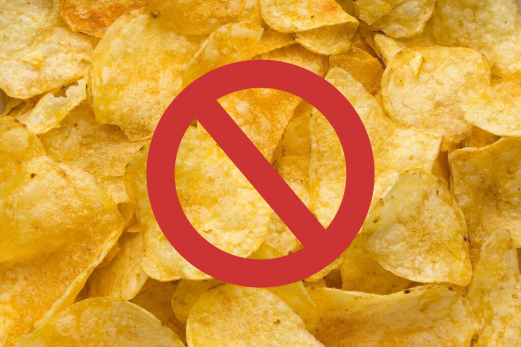 Bold Warning Sign on Potato Chips Wallpaper Background