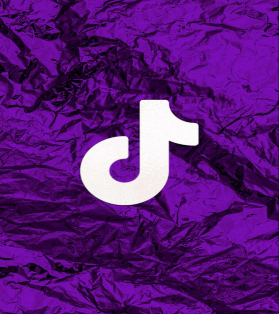 White TikTok logo on textured deep purple draped cloth background modern wallpaper design