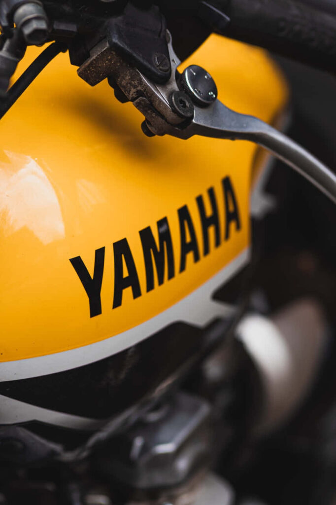 Bold Yamaha Motorcycle Wallpaper: Sleek Design on Vibrant Yellow