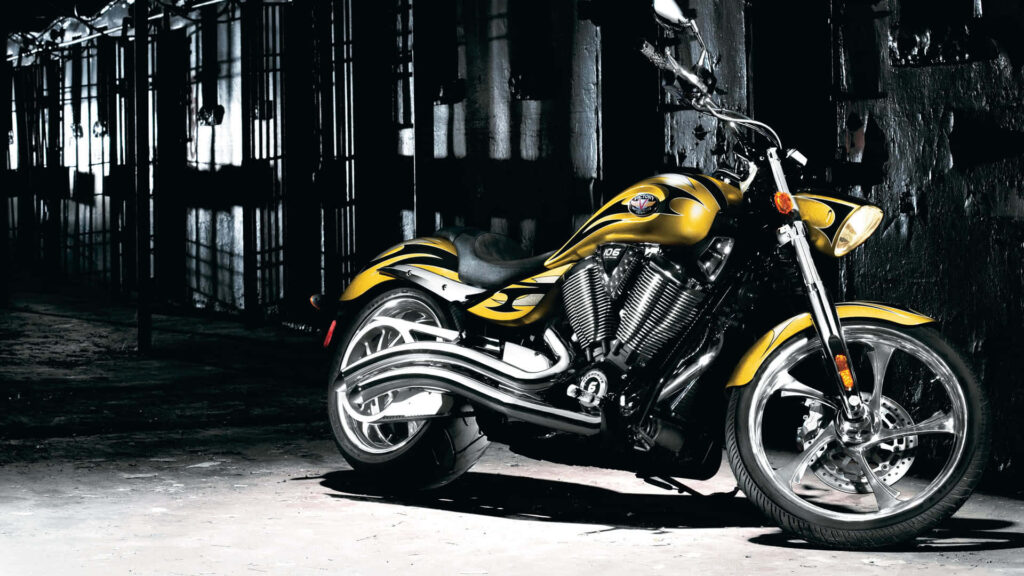 Bold Yellow Motorcycle Wallpaper in Edgy Industrial Setting