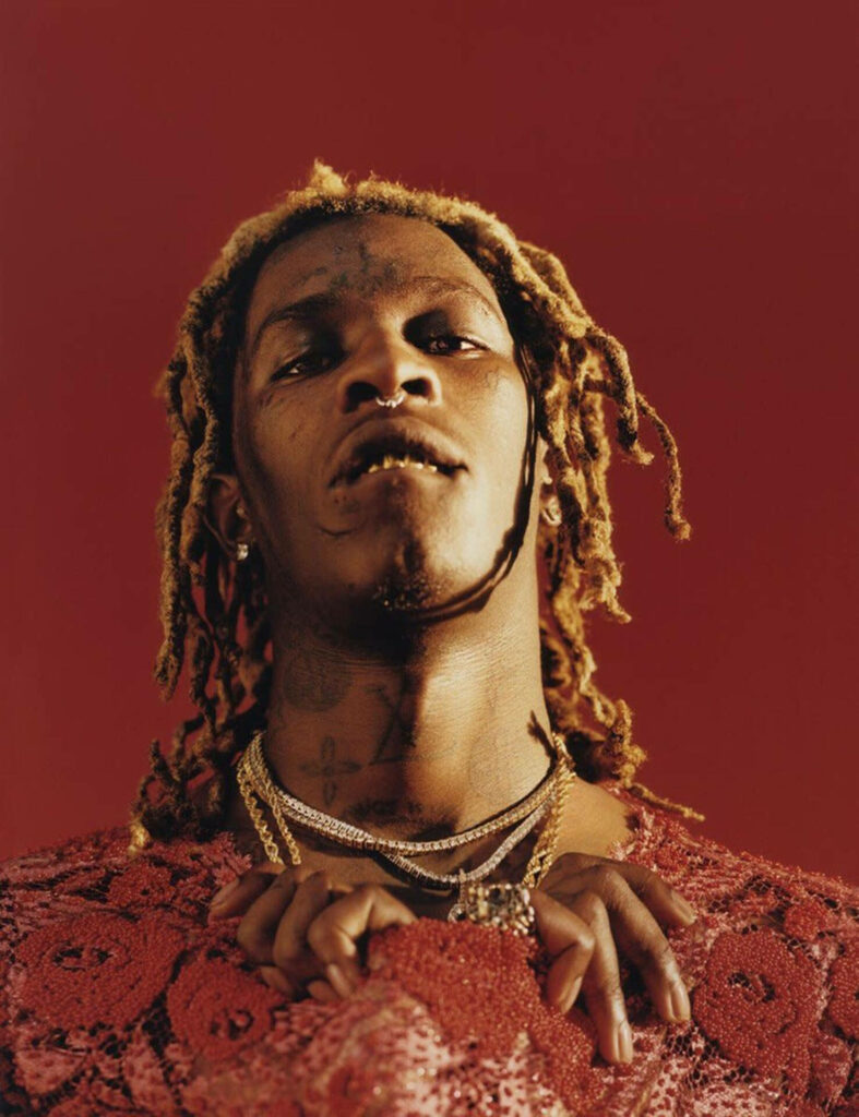 Vibrant Young Thug Wallpaper: Bold Style Against Red Backdrop