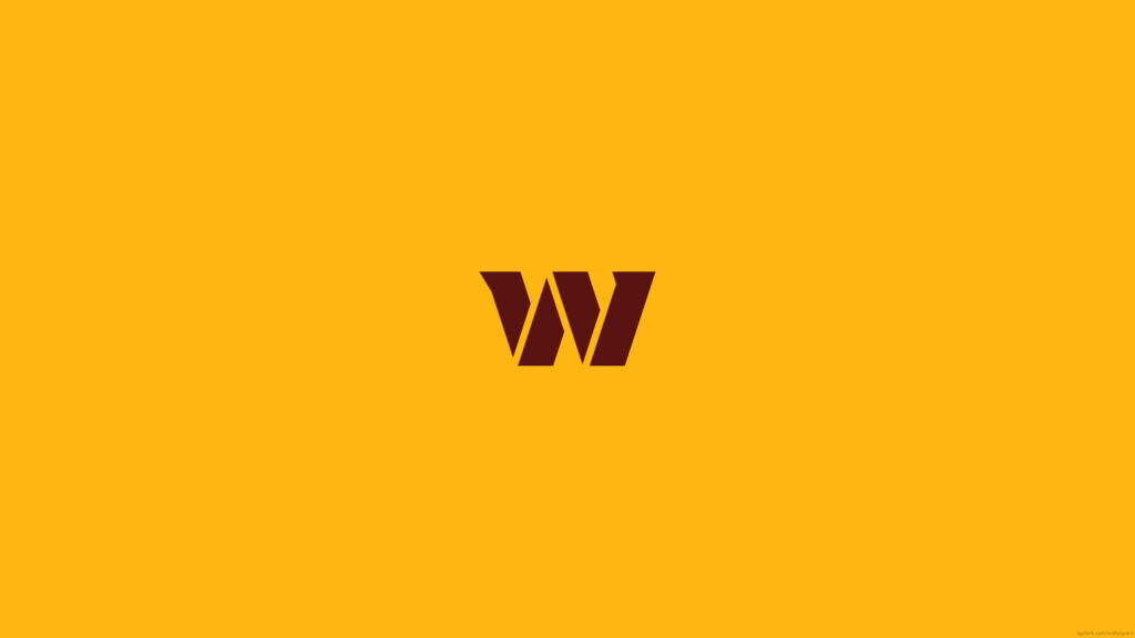 Bold and Vibrant: The Iconic Washington Commanders Football Team Logo Shining Against a Yellow Canvas! Wallpaper
